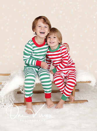 Winter Holidays: Laughing Happy Kids in Christmas Pajamas Sled i