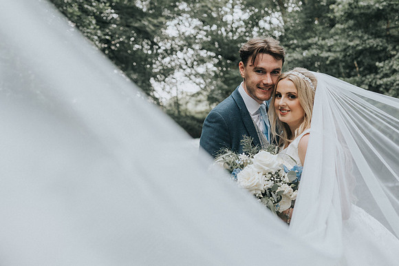 Guests clapping as the couple makes their grand entrance.