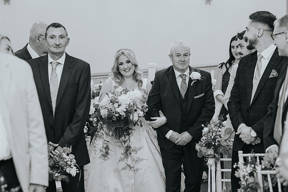 Bridesmaids in coordinating dresses, laughing together.