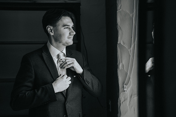 Aled adjusting his tie, a candid moment.