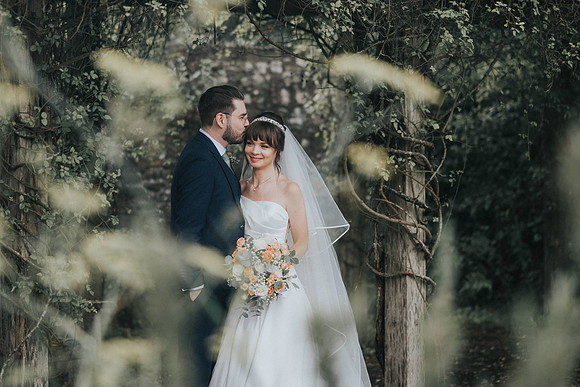 Couple sharing a tender moment in the Bear Hotel's garden.