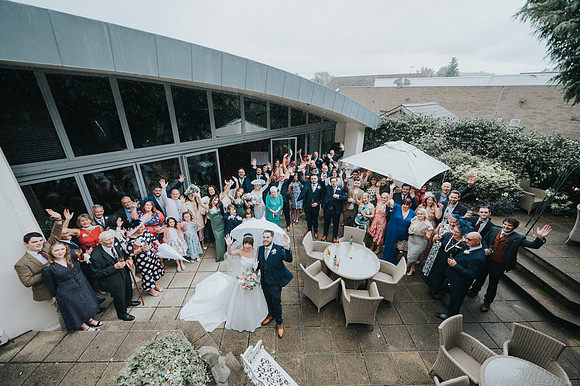 Newlyweds' joyous exit with guests showering them with petals
