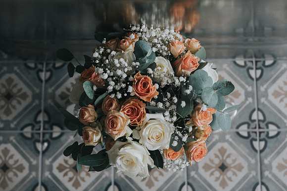 Wedding bouquet with white roses and greenery.