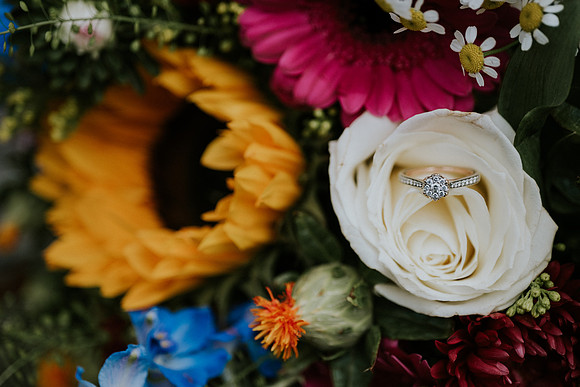 Close-up of wedding rings on bouquet