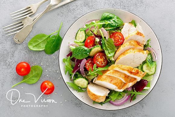 Grilled chicken breast, fillet and fresh vegetable salad of lettuce, arugula, spinach, cucumber and tomato. Healthy lunch menu. Diet food. Top view