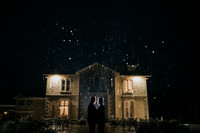 Keiran and Ryan exchanging vows under the elegant archway at St Tewdrics House.