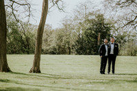 Close-up of the couple's intertwined hands, showcasing their wedding bands.
